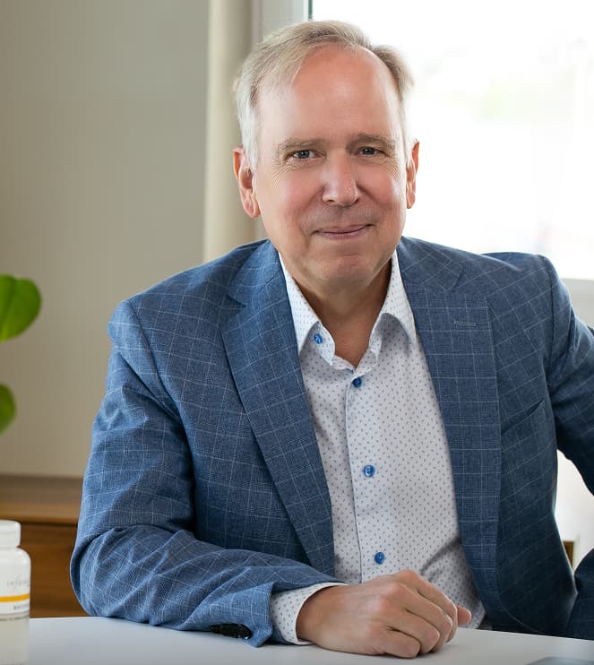 Dr. John Smith, a health and wellness expert, in his office.